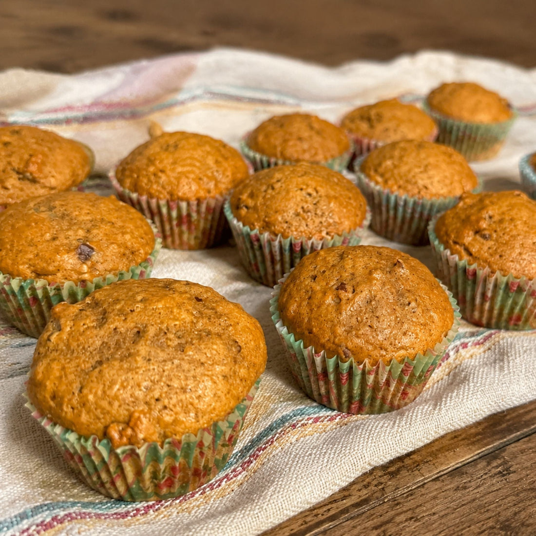 Homemade pumpkin pecan muffins arranged on a farmhouse towel