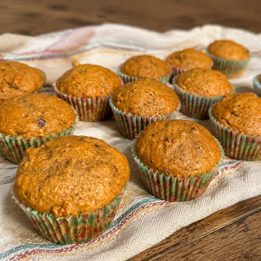 Homemade pumpkin pecan muffins arranged on a farmhouse towel